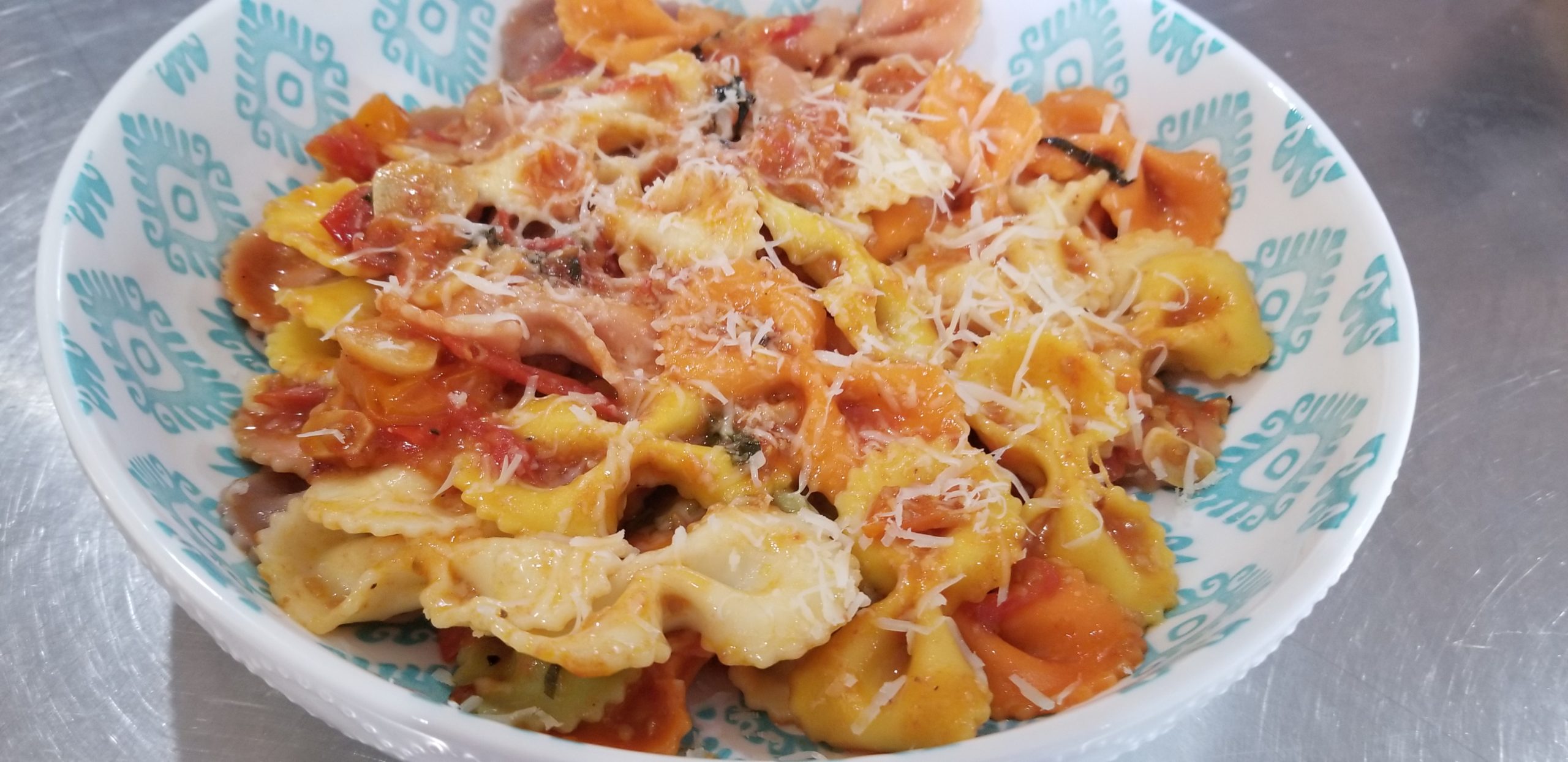 Multi-colored pasta with a fresh Greek style tomato sauce